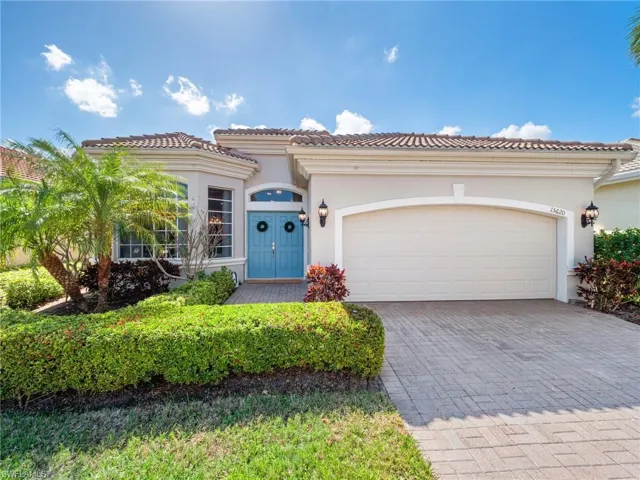 Mediterranean / spanish house with a garage, decorative driveway, and stucco siding