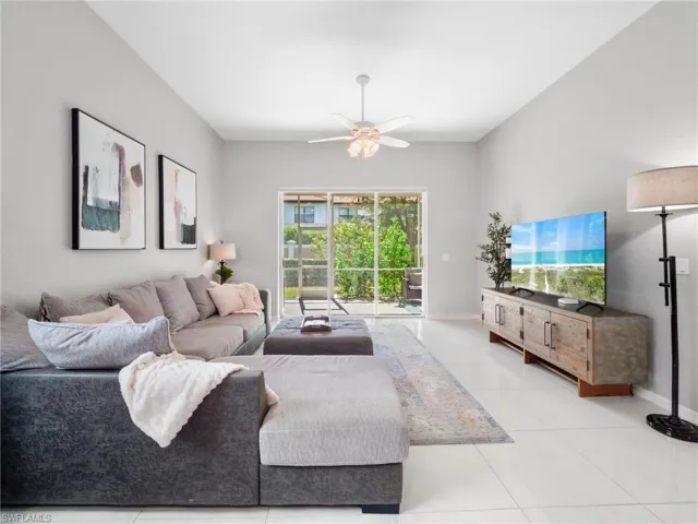 Living room featuring a ceiling fan and light tile patterned flooring