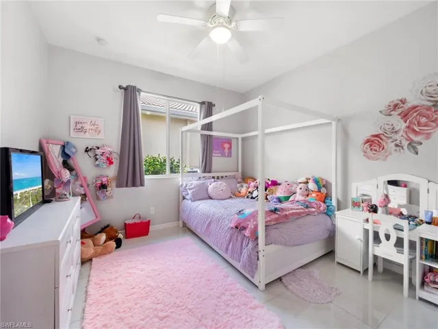 Bedroom featuring a ceiling fan and light tile patterned floors