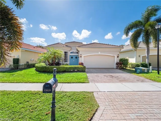 Mediterranean / spanish home featuring stucco siding, decorative driveway, a front lawn, a garage, and a tile roof
