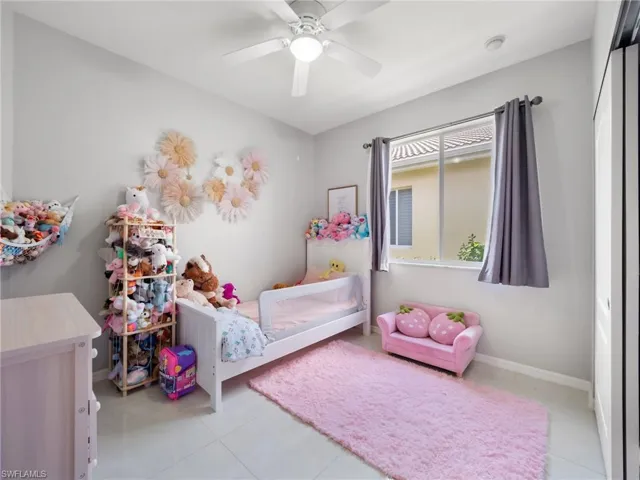Bedroom with a ceiling fan and light tile patterned floors