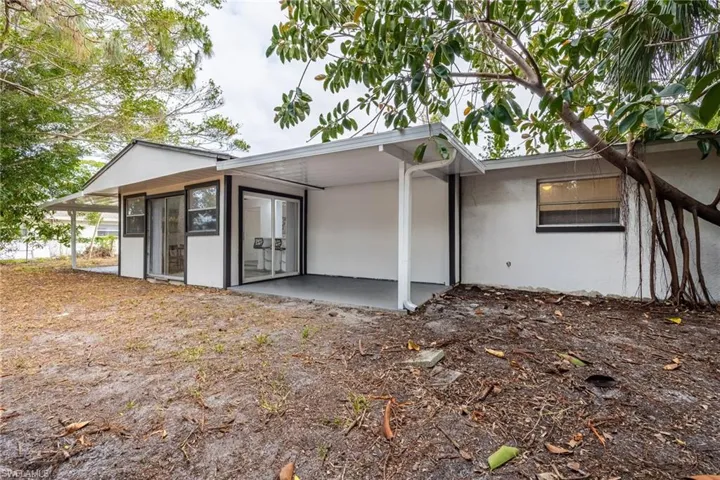 Back of house featuring stucco siding and a patio