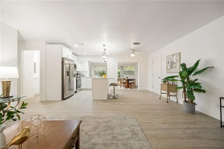 Living room featuring ceiling fan, light wood-style flooring, baseboards, and recessed lighting