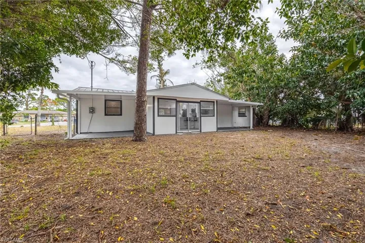 Back of house with fence