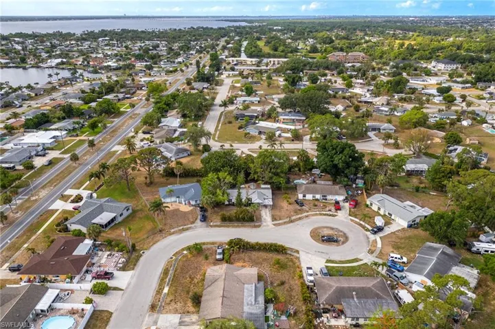 Aerial view of property's location featuring a large body of water and nearby suburban area