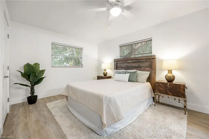 Bedroom featuring light wood-style flooring, baseboards, and ceiling fan