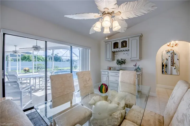 Dining space featuring a ceiling fan and lofted ceiling