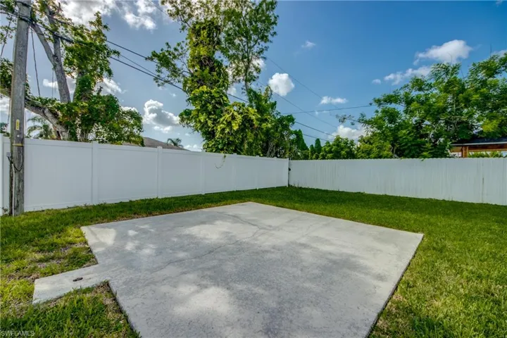 Fenced backyard with a patio