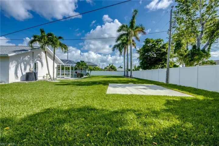 Fenced backyard with a patio area and a lanai