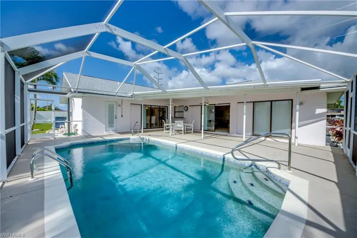 Outdoor pool featuring a patio and a lanai