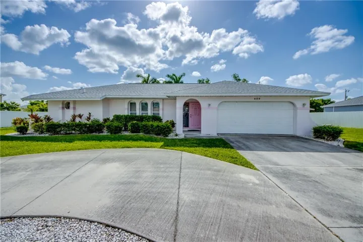 Ranch-style house with stucco siding, concrete driveway, and a garage