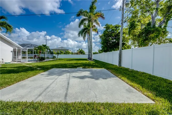 Fenced backyard with a patio and a lanai
