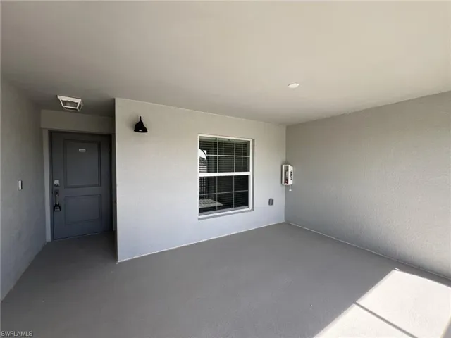 View of exterior entry featuring stucco siding
