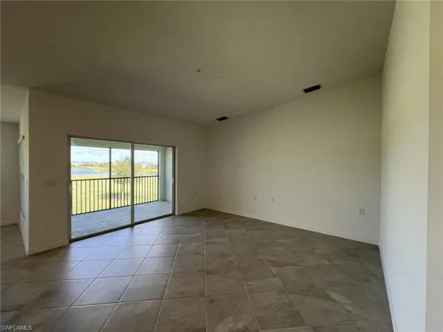 Living room with baseboards and tile patterned floors