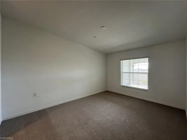 Primary bedroom with carpet flooring