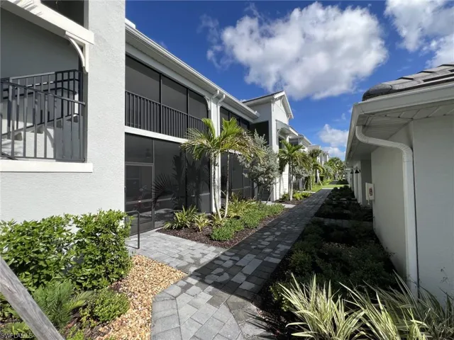 View of yard with a sunroom and a balcony
