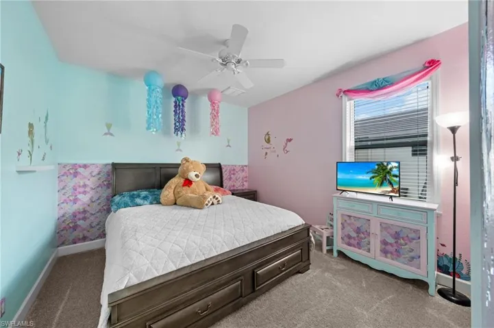 Bedroom with a closet, a ceiling fan, and carpet floors