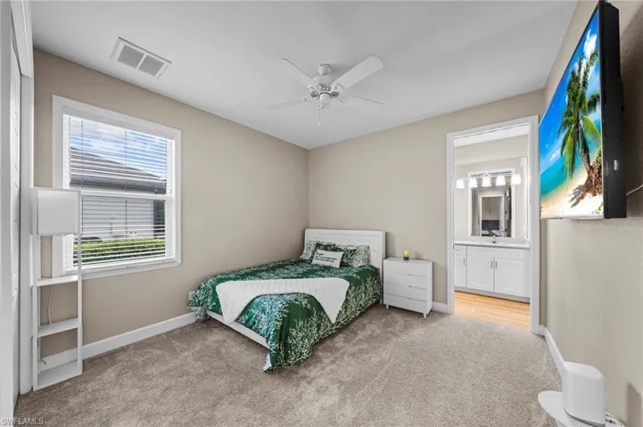 Bedroom featuring carpet, a ceiling fan, and a closet