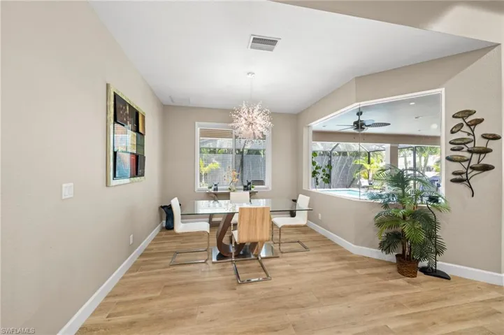 Bedroom with multiple windows, access to exterior, crown molding, carpet floors, and a raised ceiling