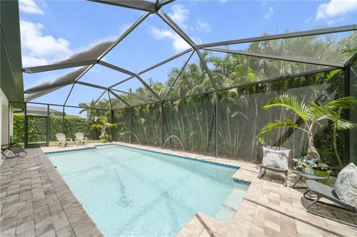 Swimming pool featuring a lanai and a patio area