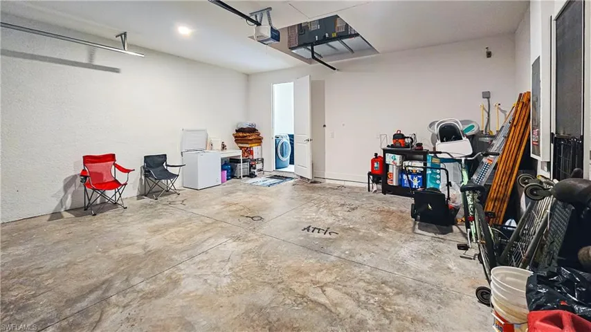 Garage with washer and clothes dryer and a garage door opener