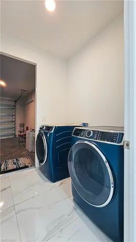 Washroom with washer and dryer, marble finish floors, recessed lighting, and an office area