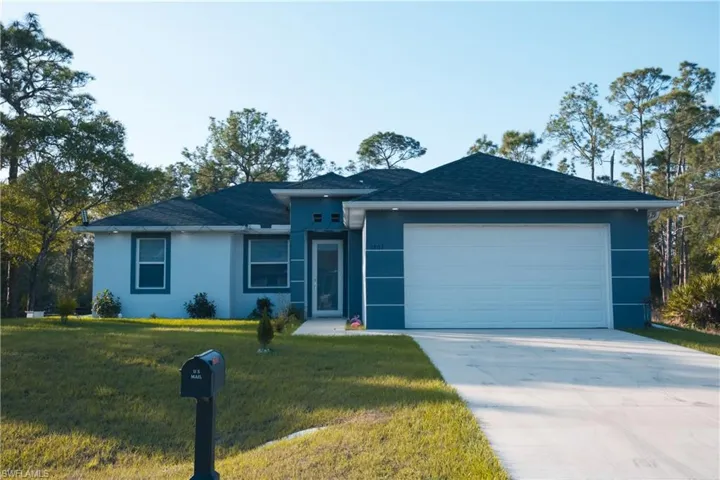 Single story home with a front yard, stucco siding, roof with shingles, concrete driveway, and an attached garage