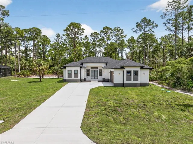 Contemporary single-story residence featuring a dark gray shingle roof and white stucco exterior with dark gray trim