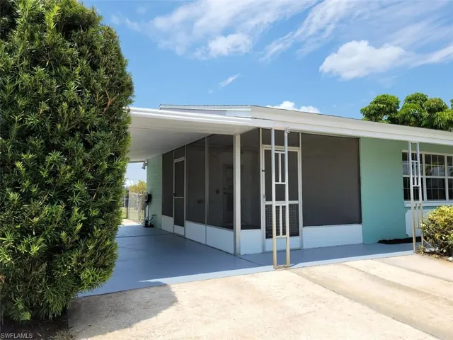 View of property exterior with a sunroom