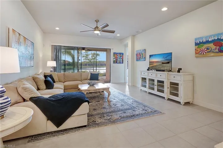 Living room featuring ceiling fan and light tile patterned floors