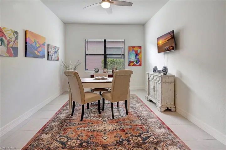 Dining room with ceiling fan and light tile patterned floors
