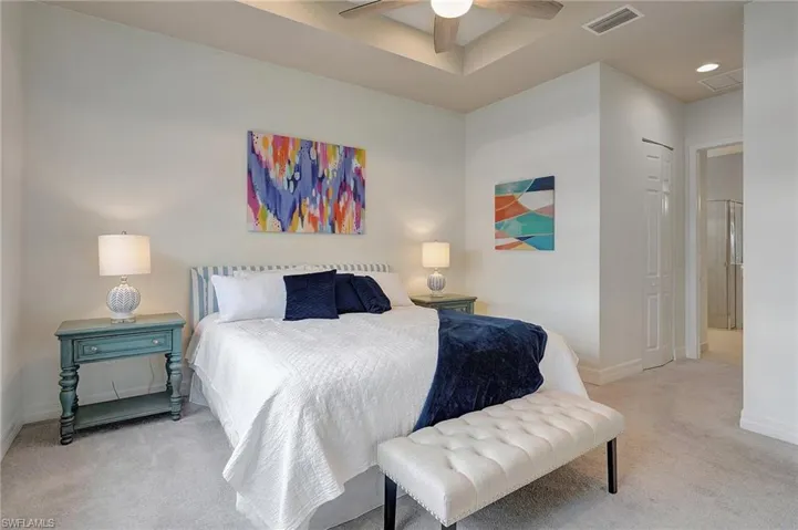 Carpeted bedroom featuring a closet and ceiling fan