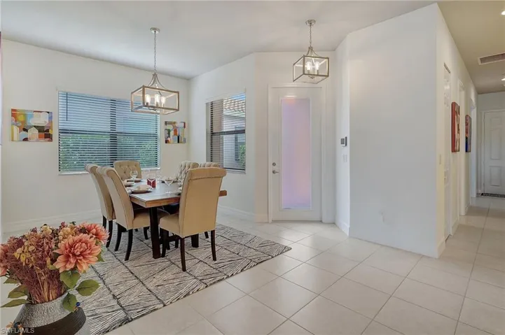 Dining space featuring light tile patterned floors