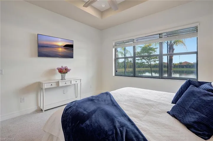 Bedroom featuring ceiling fan and light colored carpet