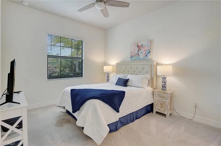 Carpeted bedroom with ceiling fan
