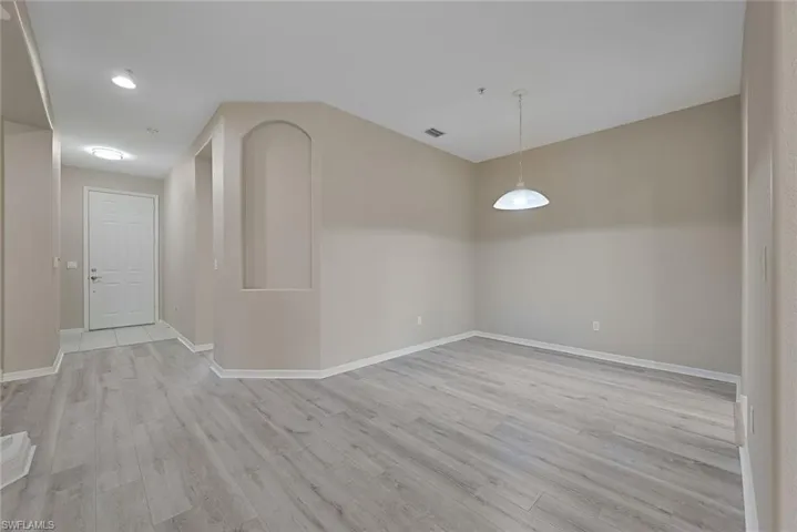 Foyer and Dining room with baseboards and luxury vinyl flooring