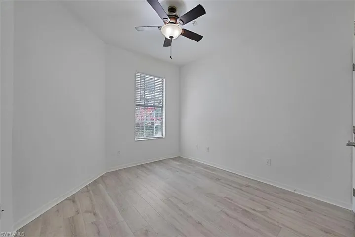 Guest Bedroom room with a ceiling fan with new flooring