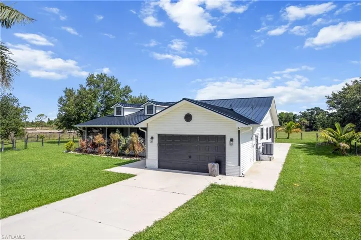 View of front facade with a garage and concrete driveway