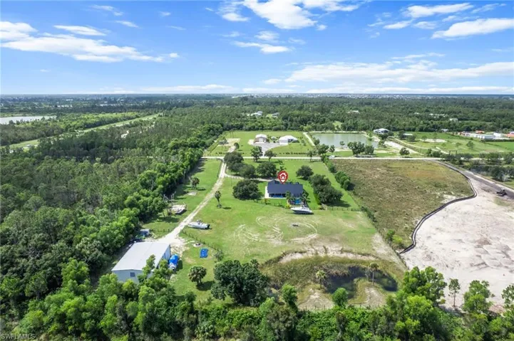 View of property location featuring a heavily wooded area and a nearby body of water