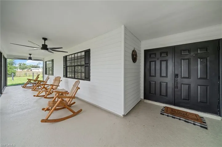 Property entrance featuring covered porch and ceiling fan