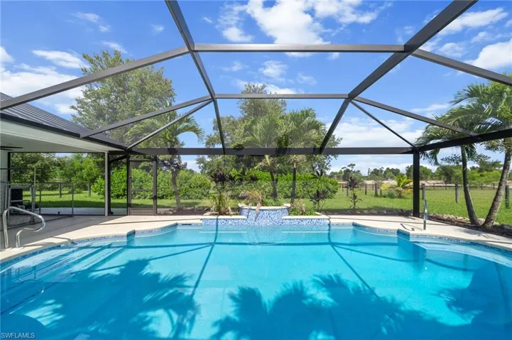Outdoor pool with a lanai and a patio area