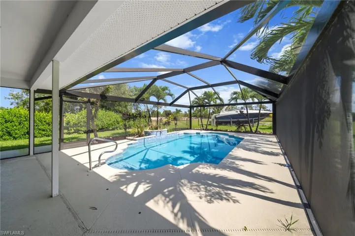 Swimming pool featuring a patio and a lanai