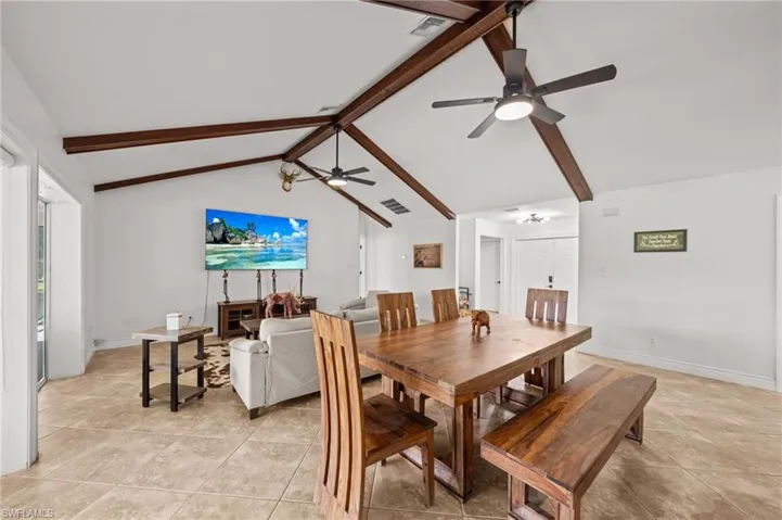 Dining space with a ceiling fan and light tile patterned floors