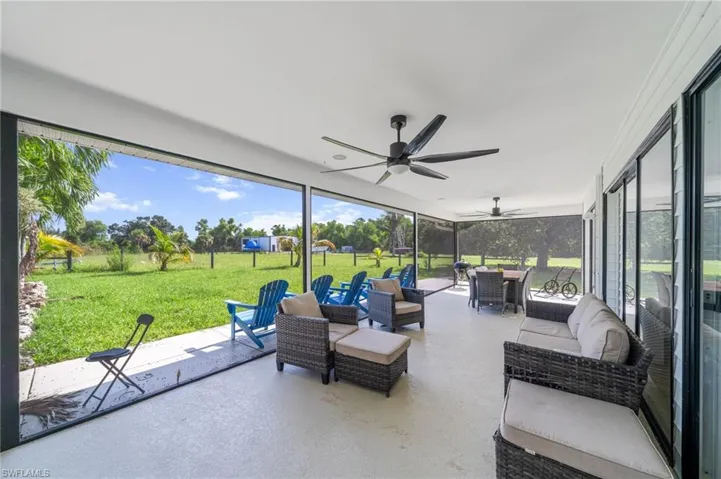 Sunroom featuring ceiling fan, outdoor lounge area, outdoor dining space, and healthy amount of natural light
