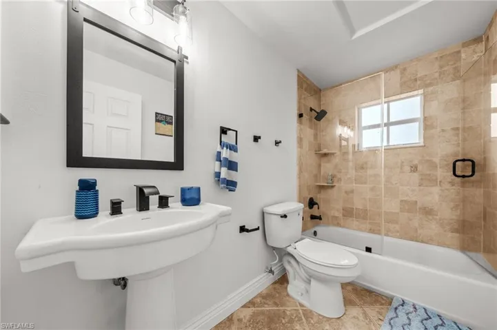 Full bathroom featuring shower / bathtub combination and tile patterned flooring