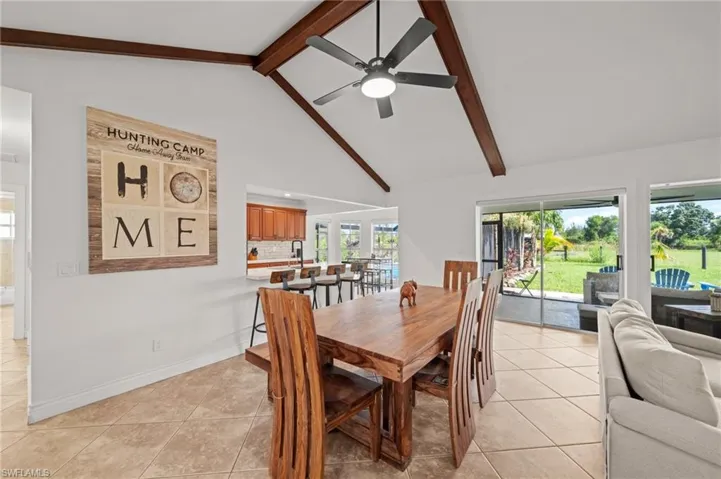 Dining area featuring light tile patterned flooring and a ceiling fan
