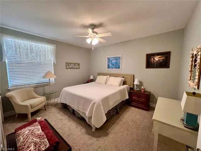 Bedroom featuring light carpet and ceiling fan
