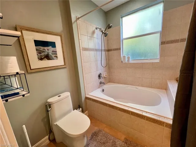 Full bathroom featuring tiled shower / bath and tile patterned floors