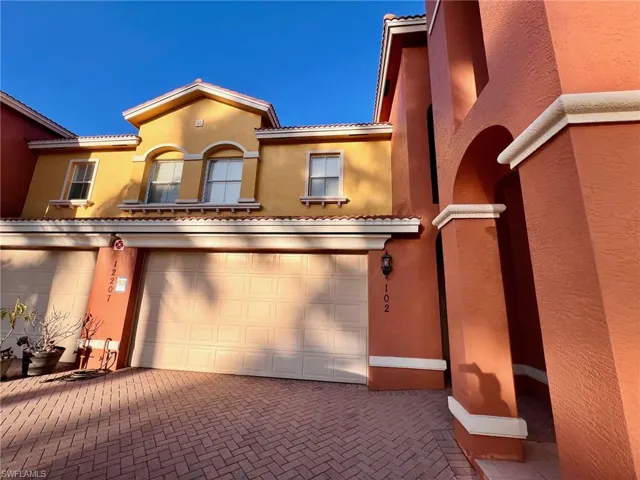 Mediterranean / spanish-style house featuring stucco siding, decorative driveway, a garage, and a tile roof