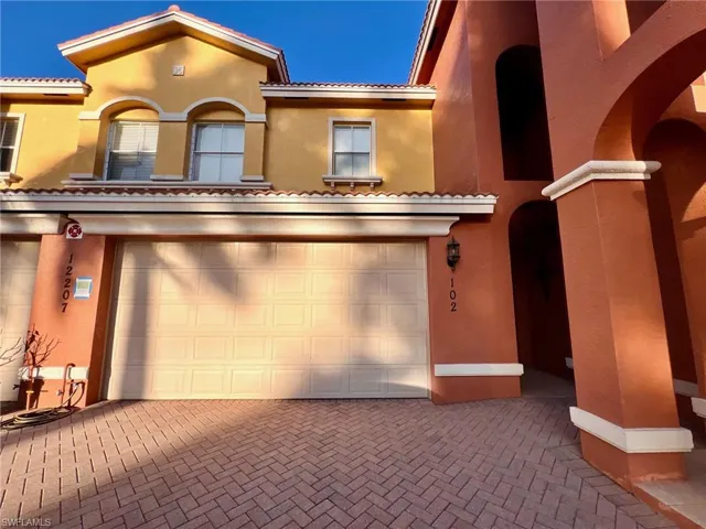 Mediterranean / spanish-style house featuring stucco siding, decorative driveway, and a tile roof